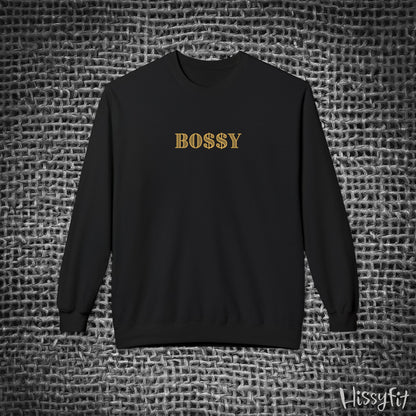Black sweatshirt with 'BOSSY' in gold on a textured gray background