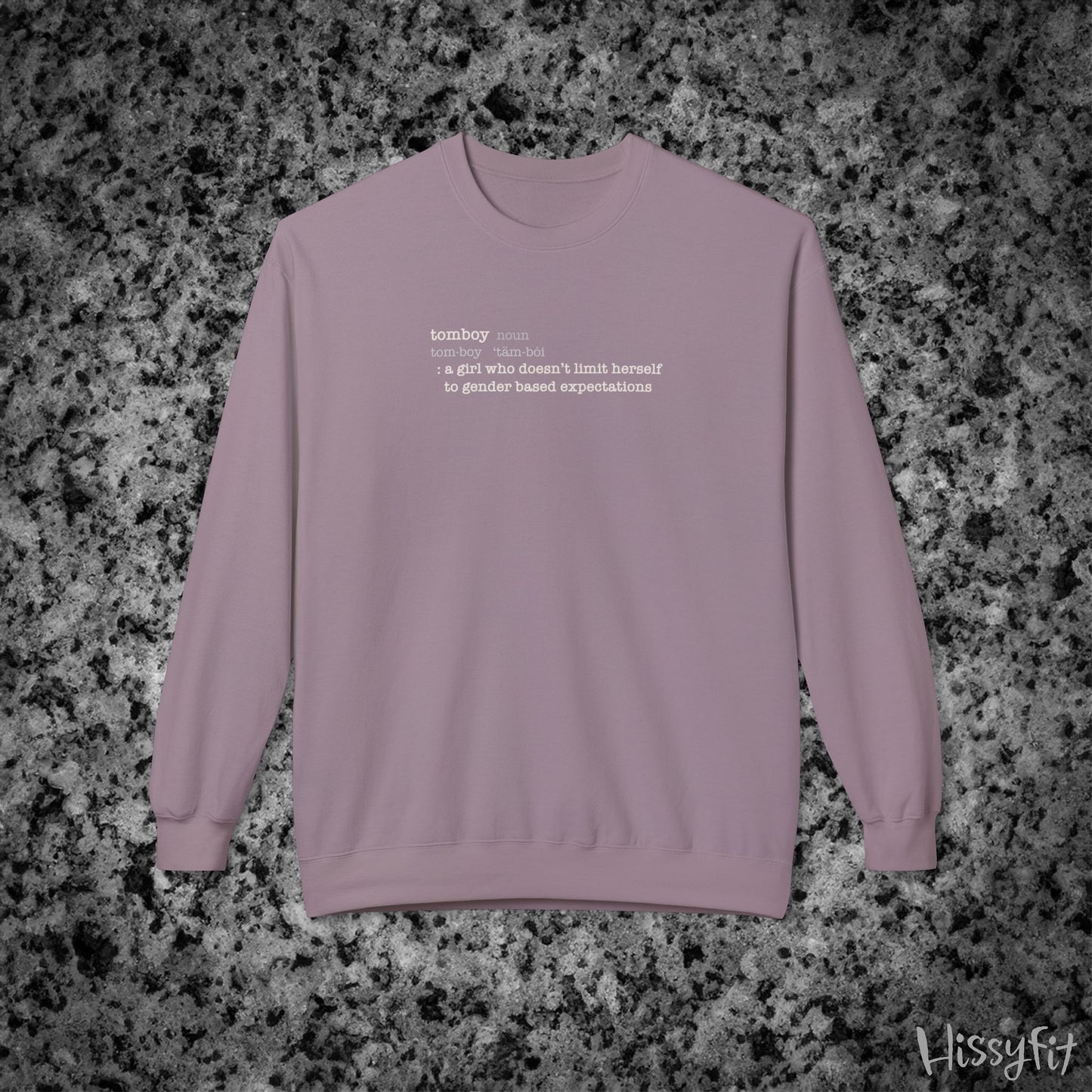 Light Purple sweatshirt with text definition of "Tomboy" on a gray and black speckled background