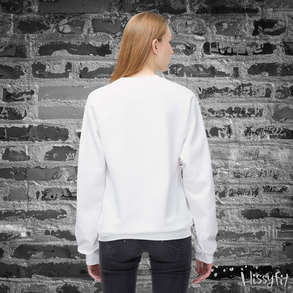 Person wearing a white sweatshirt standing against a textured brick wall.