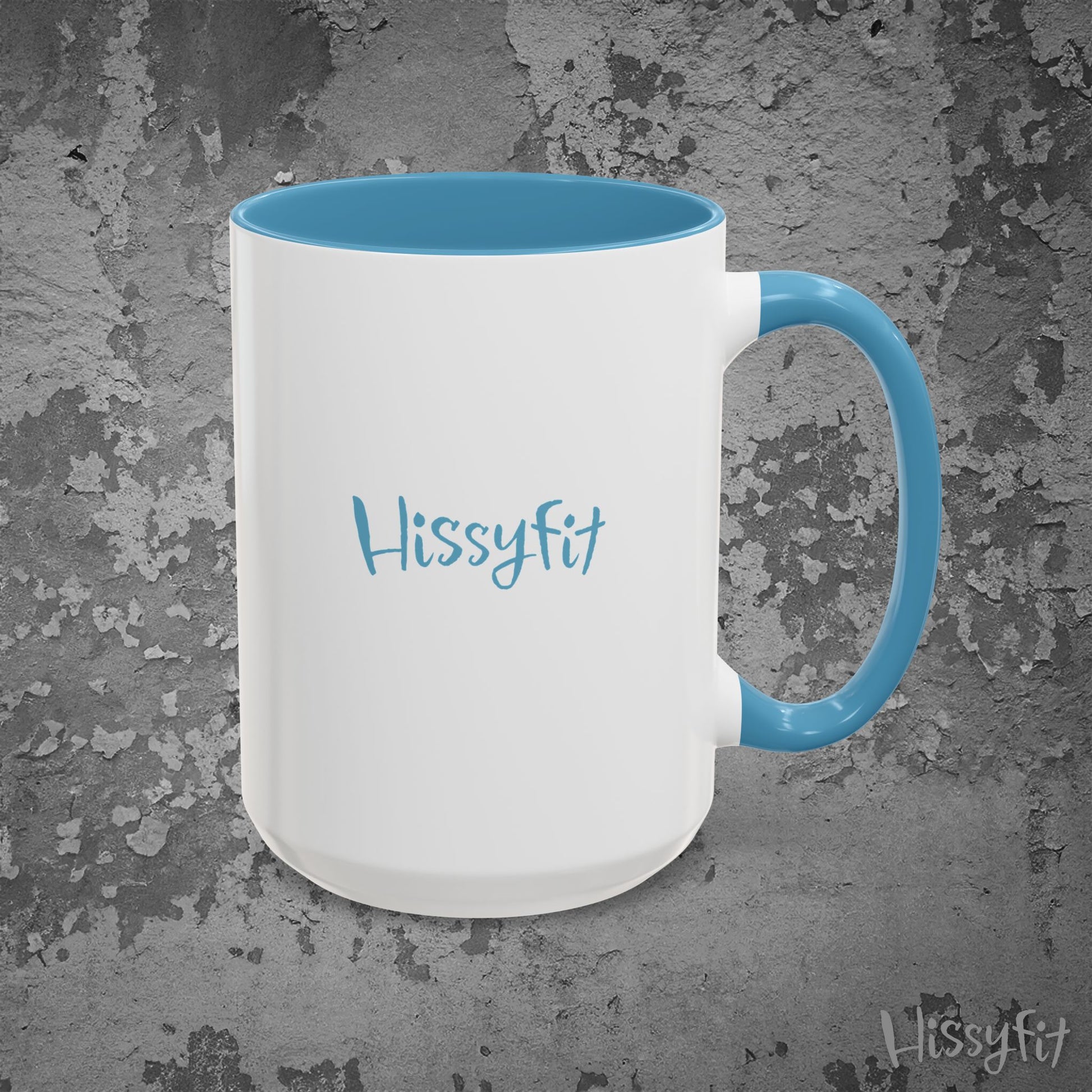 White mug with blue interior and handle on a textured gray background, featuring the word 'Hissyfit'.