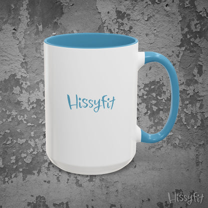 White mug with blue interior and handle on a textured gray background, featuring the word 'Hissyfit'.