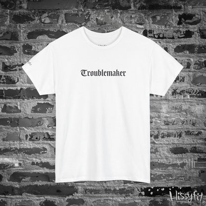 White t-shirt with 'Troublemaker' text on a brick wall background