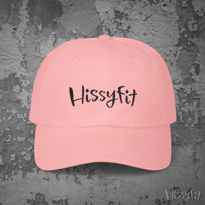 Pink cap with 'Hissyfit' text on a textured gray background