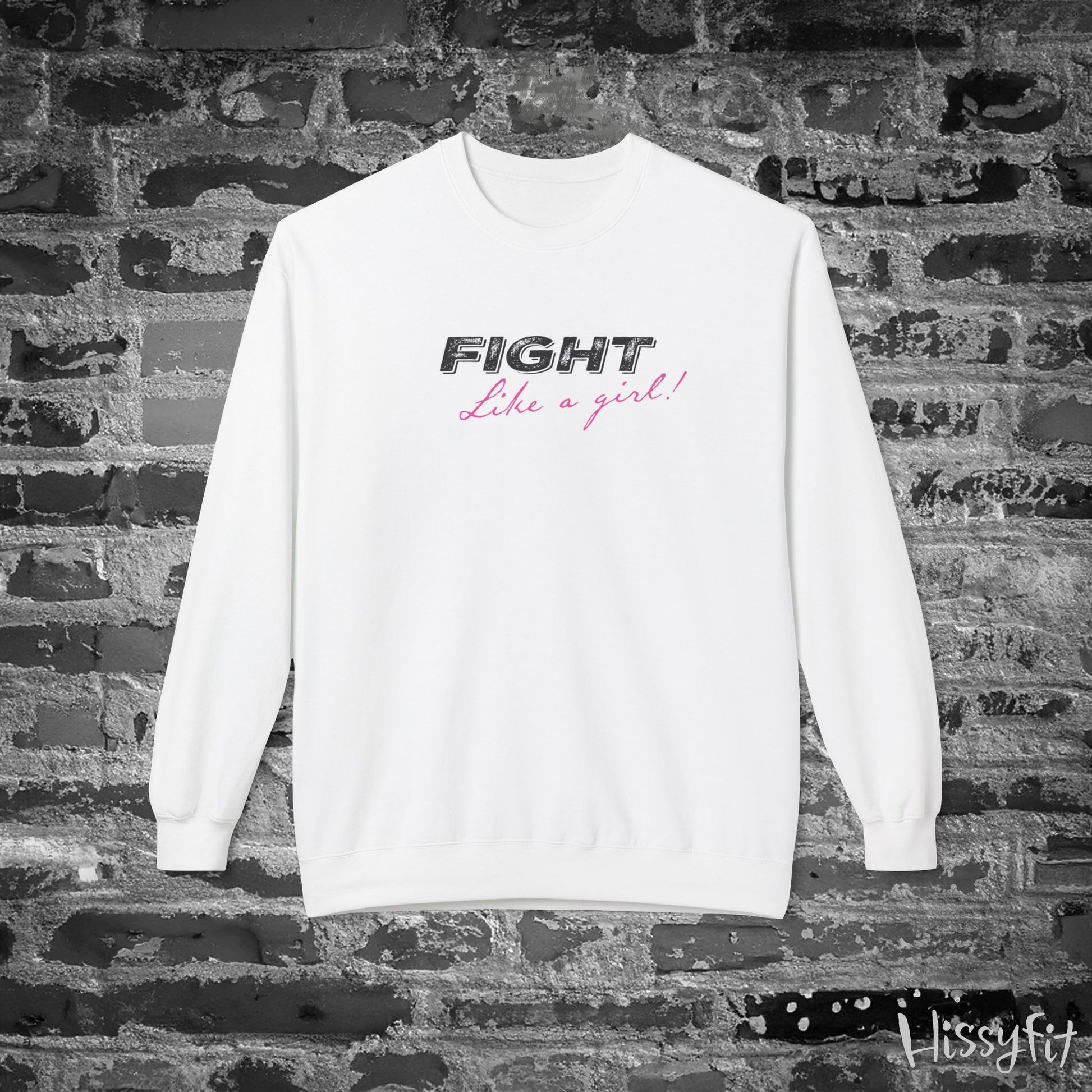 White sweatshirt with 'Fight Like a Girl' text on a brick wall background