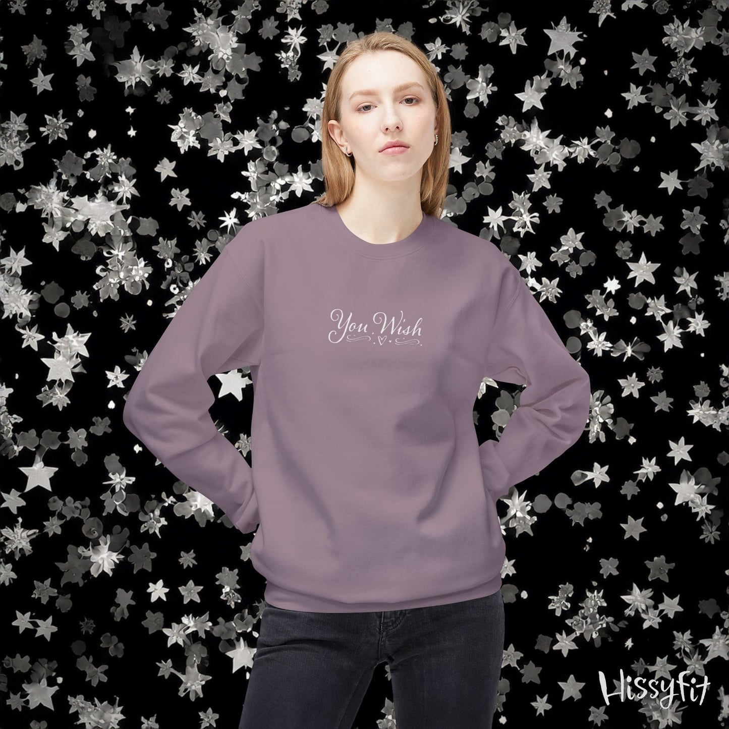 Person wearing a purple sweatshirt with text on a star-patterned background