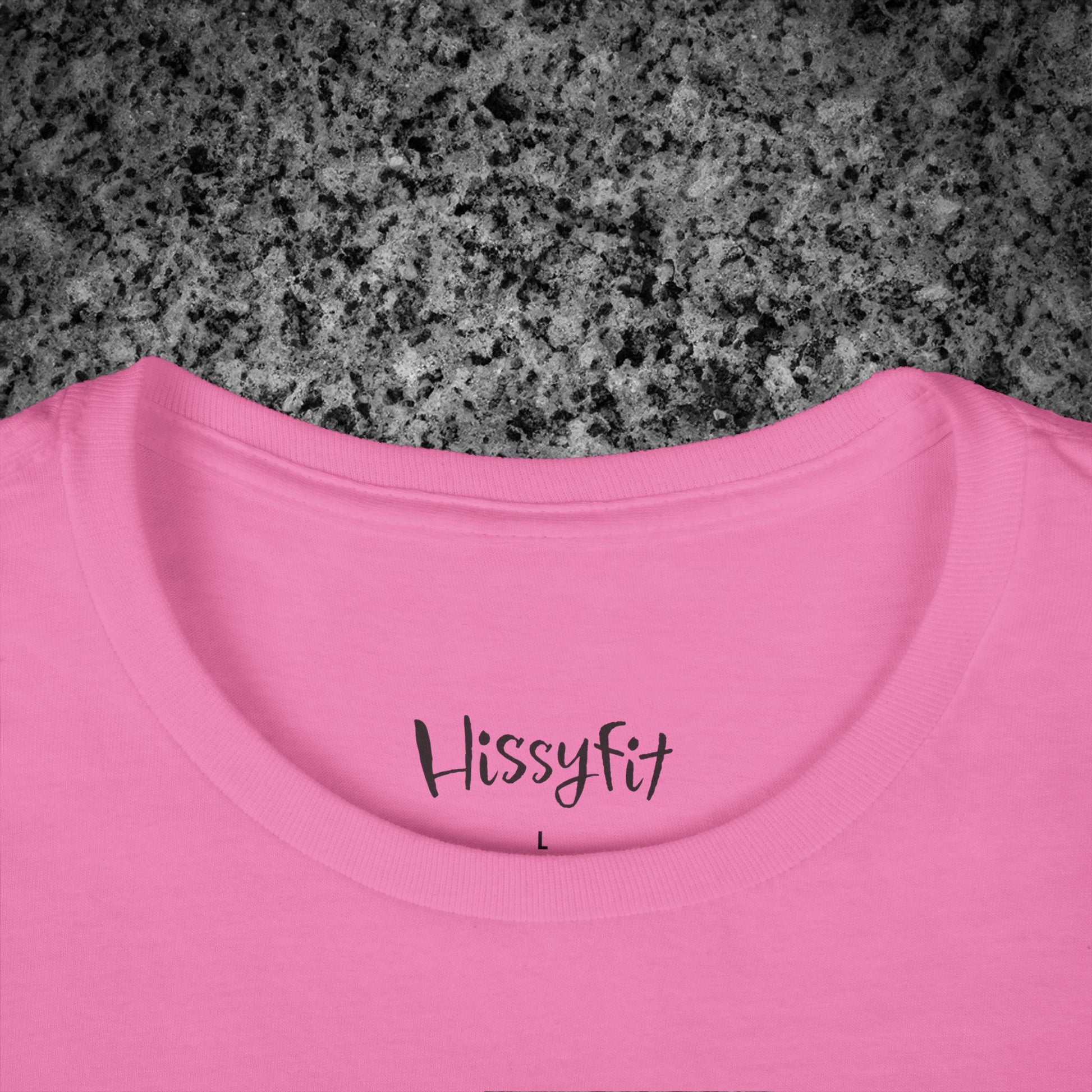 Pink t-shirt with 'Hissyfit' text on a gray granite surface