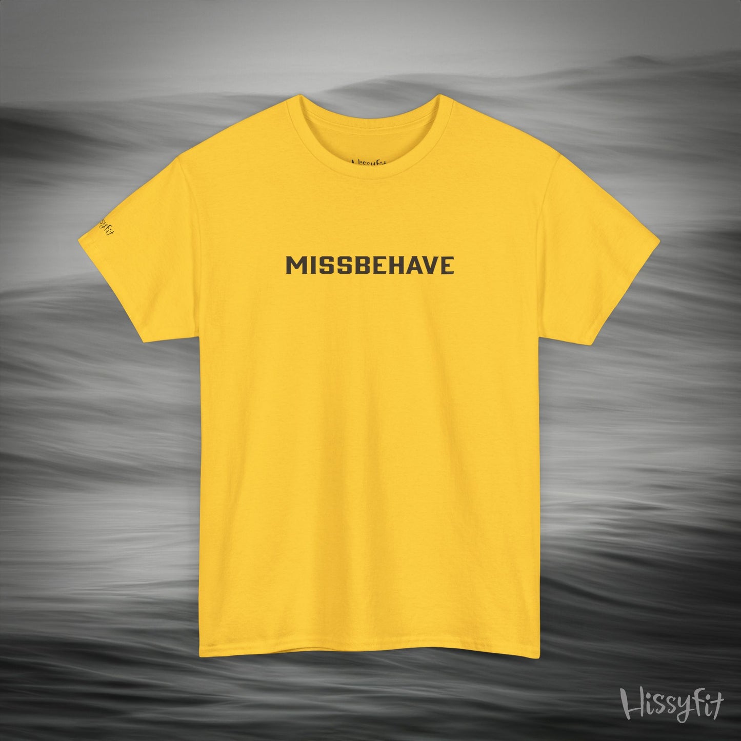 Yellow t-shirt with 'MISSBEHAVE' text on a gray background