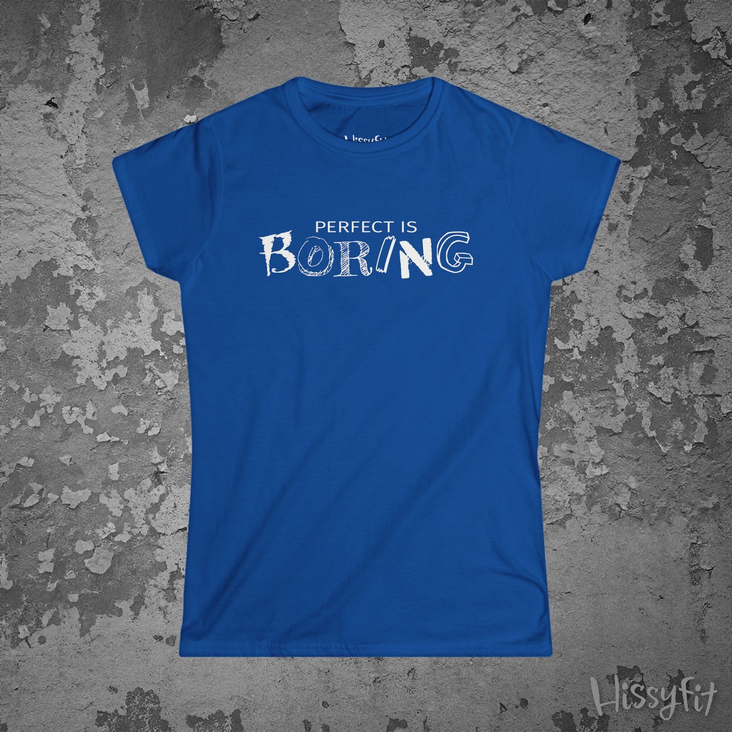 Blue t-shirt with 'PERFECT IS BORING' text on a textured gray background