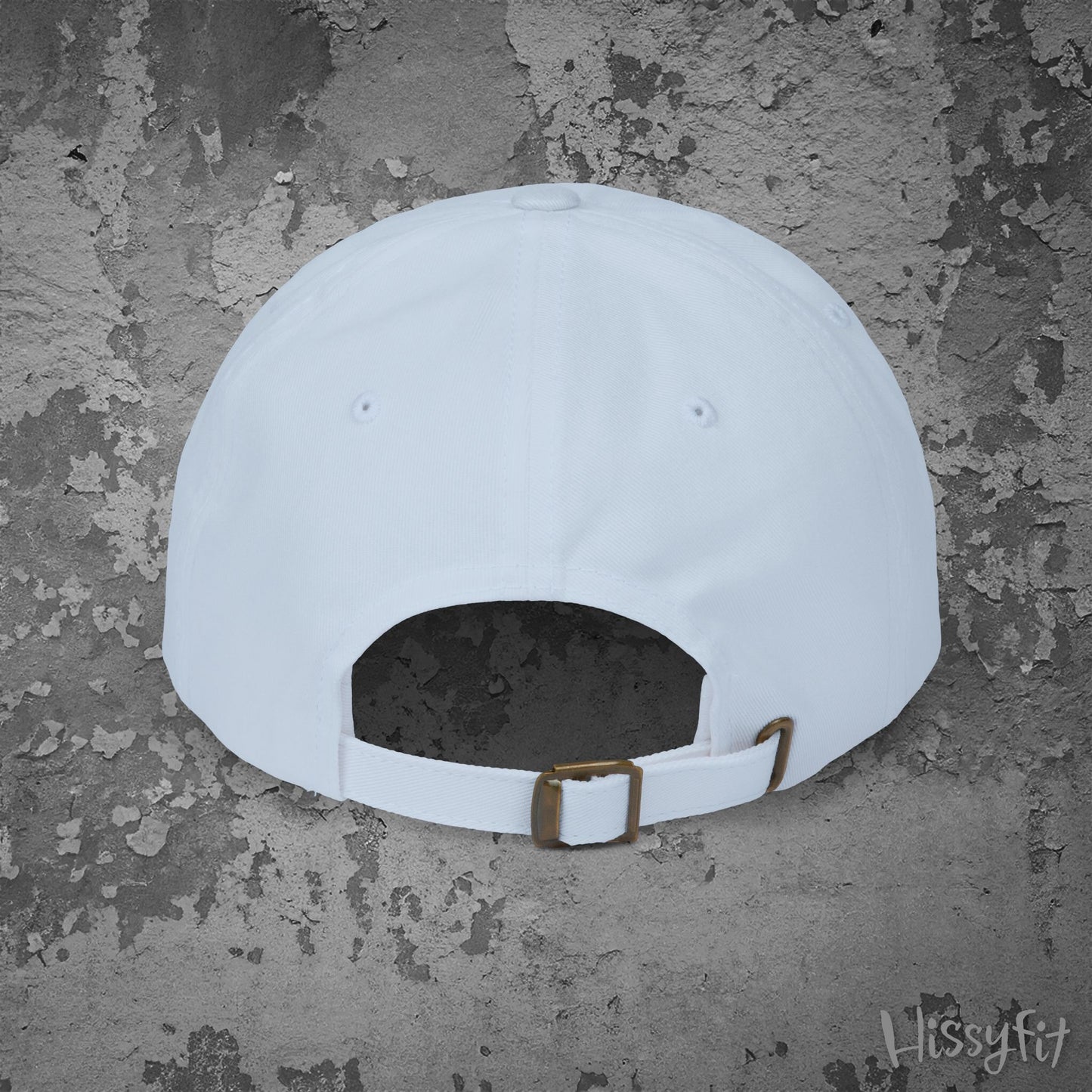 White cap with a brown strap on a textured gray background