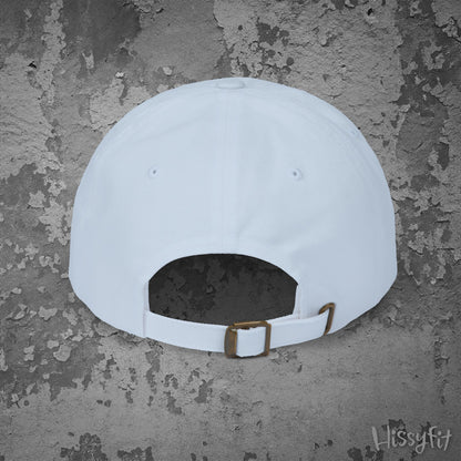 White cap with a brown strap on a textured gray background