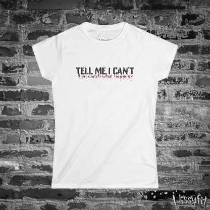 White t-shirt with text 'Tell me I can't then watch what happens' on a brick wall background