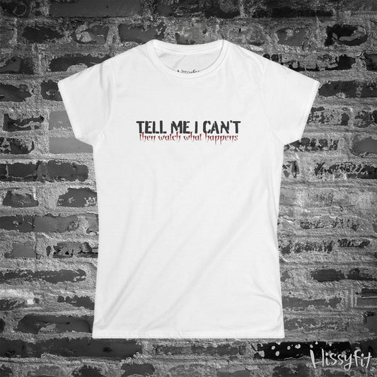 White t-shirt with text 'Tell me I can't then watch what happens' on a brick wall background