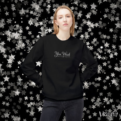 Person wearing a black sweatshirt with 'You Wish' text against a star-patterned background