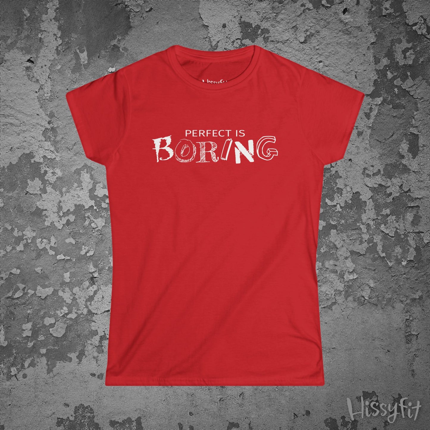 Red t-shirt with 'PERFECT IS BORING' text on a textured gray background