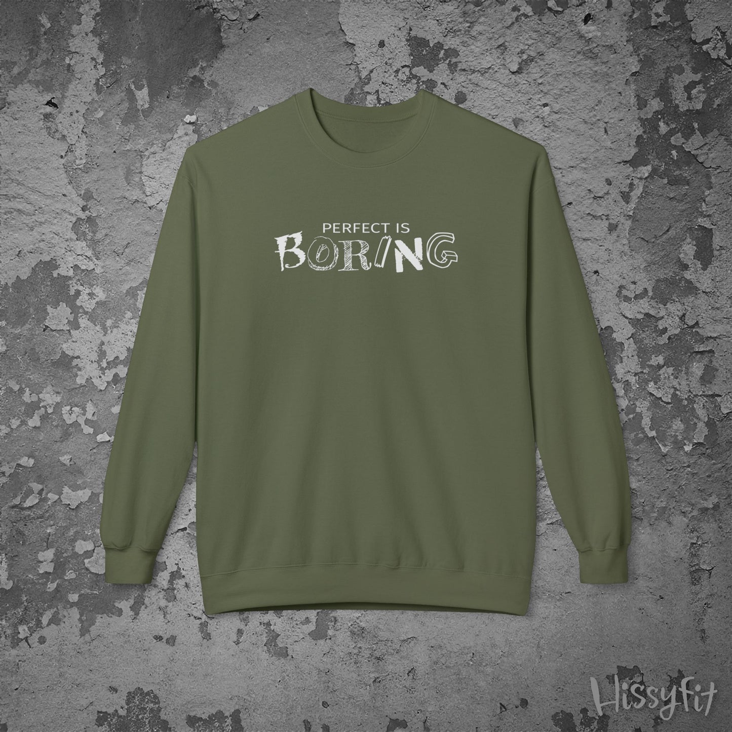 Green sweatshirt with 'PERFECT IS BORING' text on a textured gray background