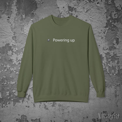 Green sweatshirt with 'Powering up' text on a textured gray background