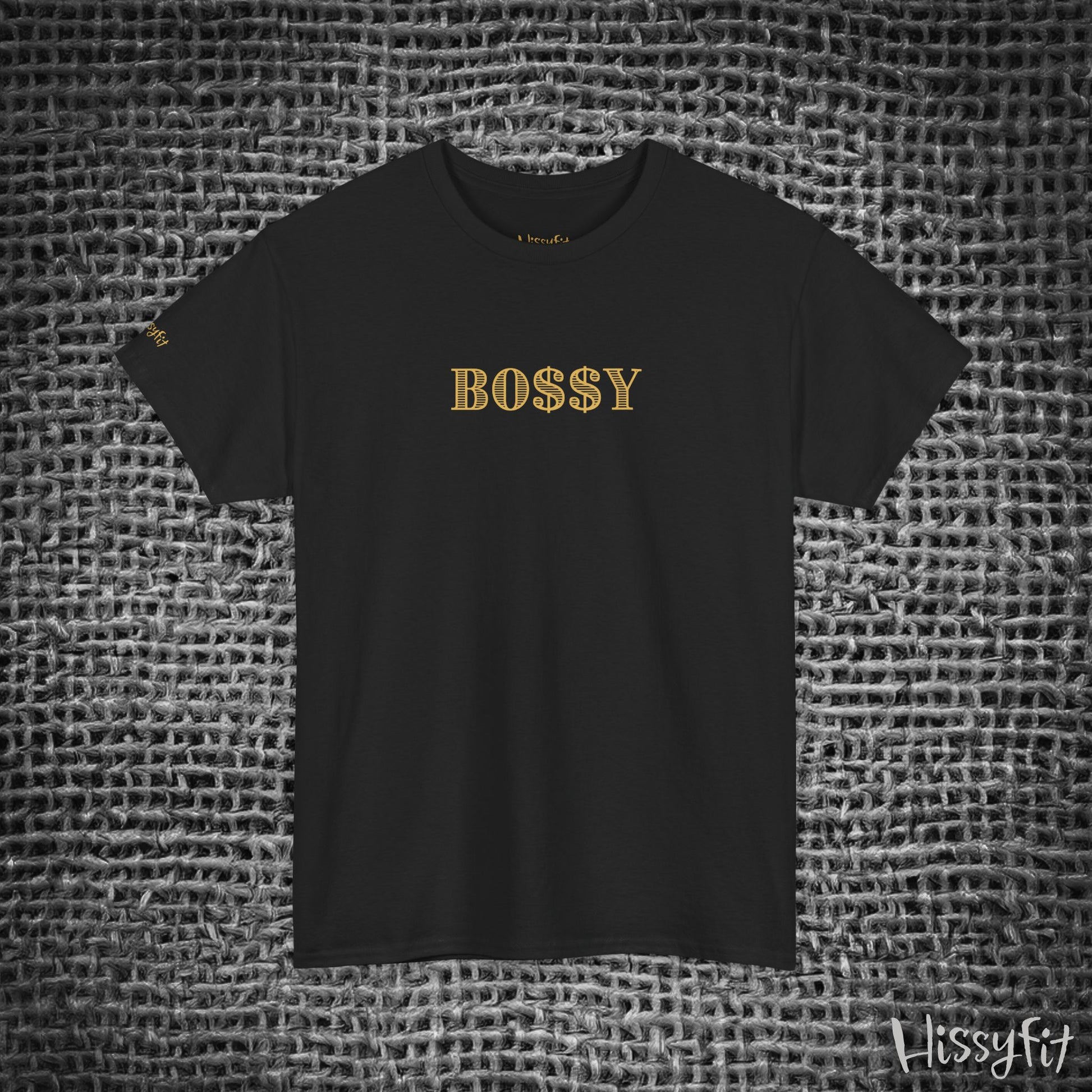 Black t-shirt with 'BOSSY' in gold on a textured gray background