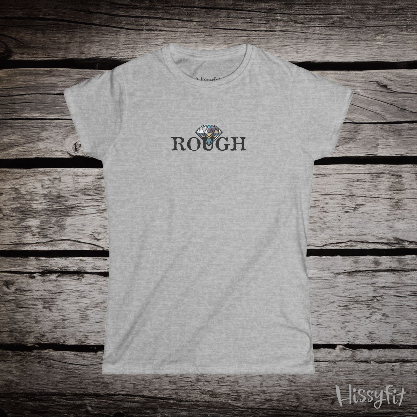 Gray t-shirt with a graphic diamond in 'Rough' text on a wooden surface, featuring the brand 'Hissyfit'.