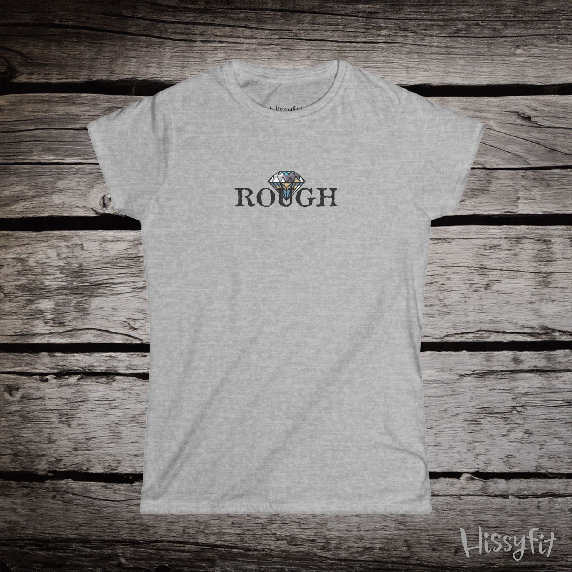 Gray t-shirt with a graphic diamond in 'Rough' text on a wooden surface, featuring the brand 'Hissyfit'.