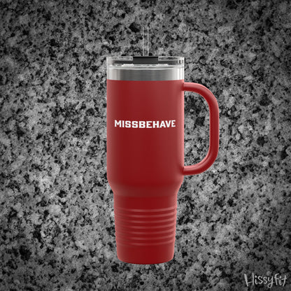 Red travel mug with 'MISSBEHAVE' text on a gray granite background