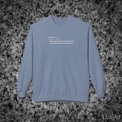 Blue sweatshirt with text definition of "Tomboy" on a gray and black speckled background