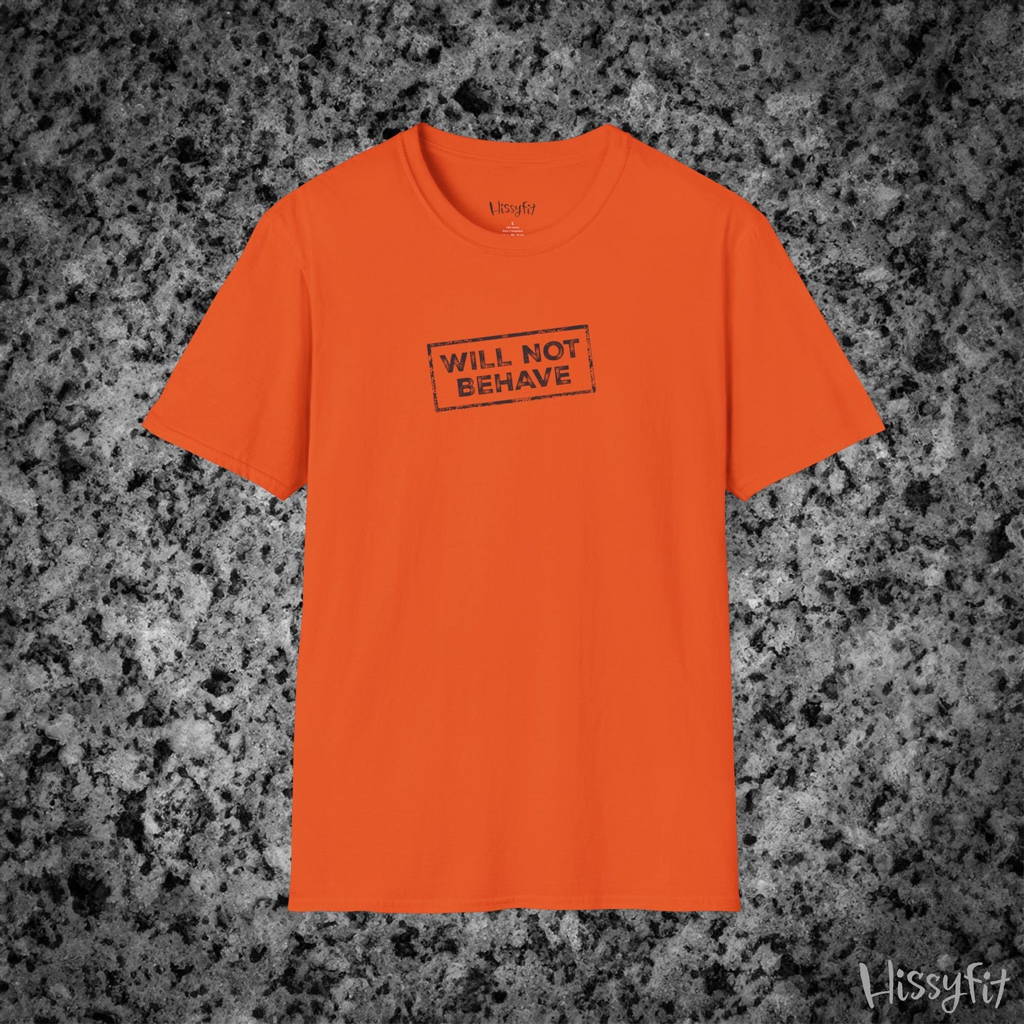 Orange t-shirt with 'WILL NOT BEHAVE' text on a gray textured background