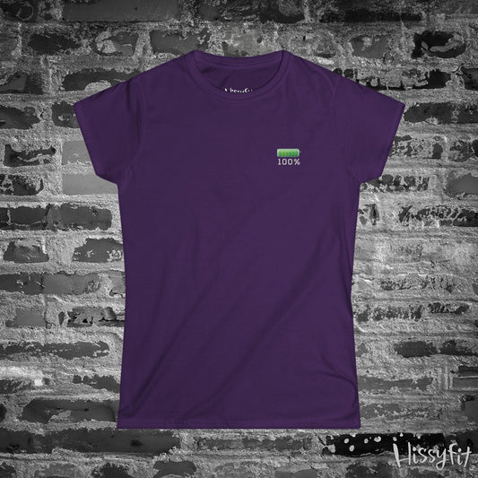 Purple t-shirt with a green fully charged battery icon on a brick wall background