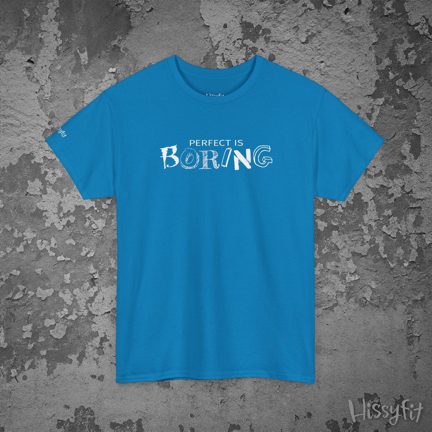 Blue t-shirt with 'PERFECT IS BORING' text on a textured gray background