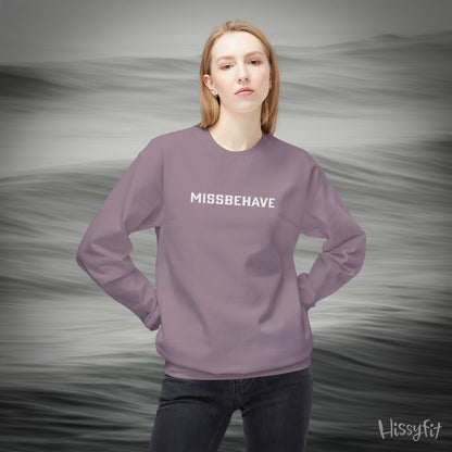Person wearing a purple sweatshirt with 'MISSBEHAVE' text against a gray background