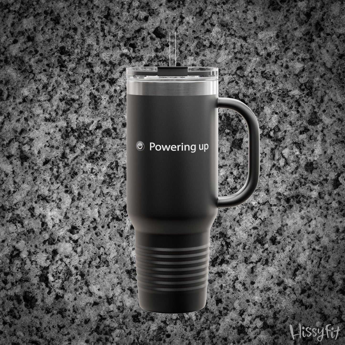 Black travel mug with 'Powering up' text on a gray granite background