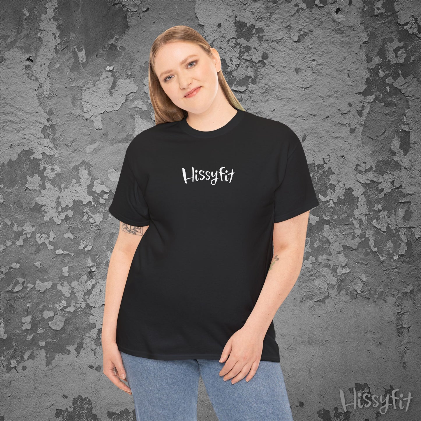 Person wearing a black 'Hissyfit' t-shirt against a textured gray background