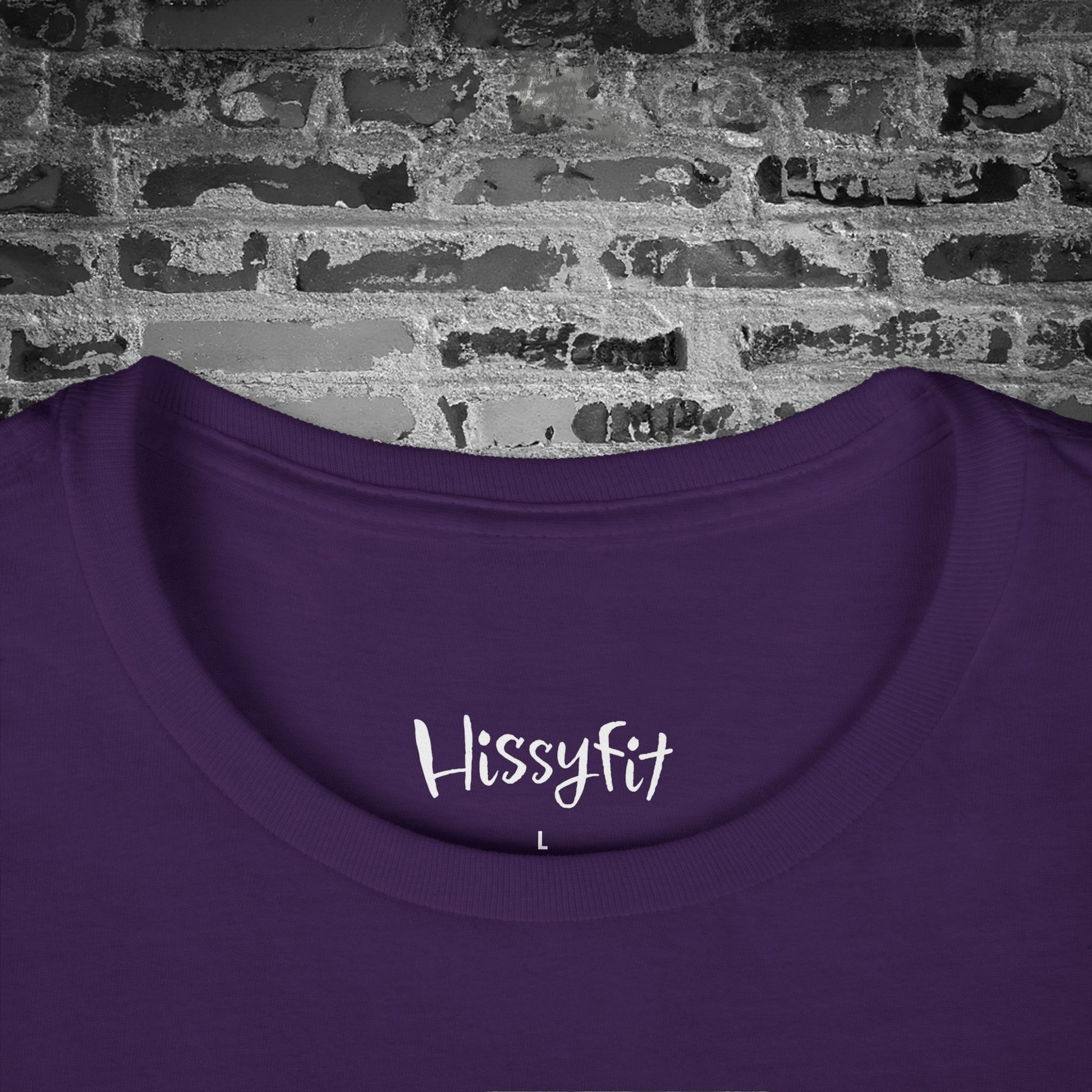 Purple shirt with 'Hissyfit' text on a brick wall background
