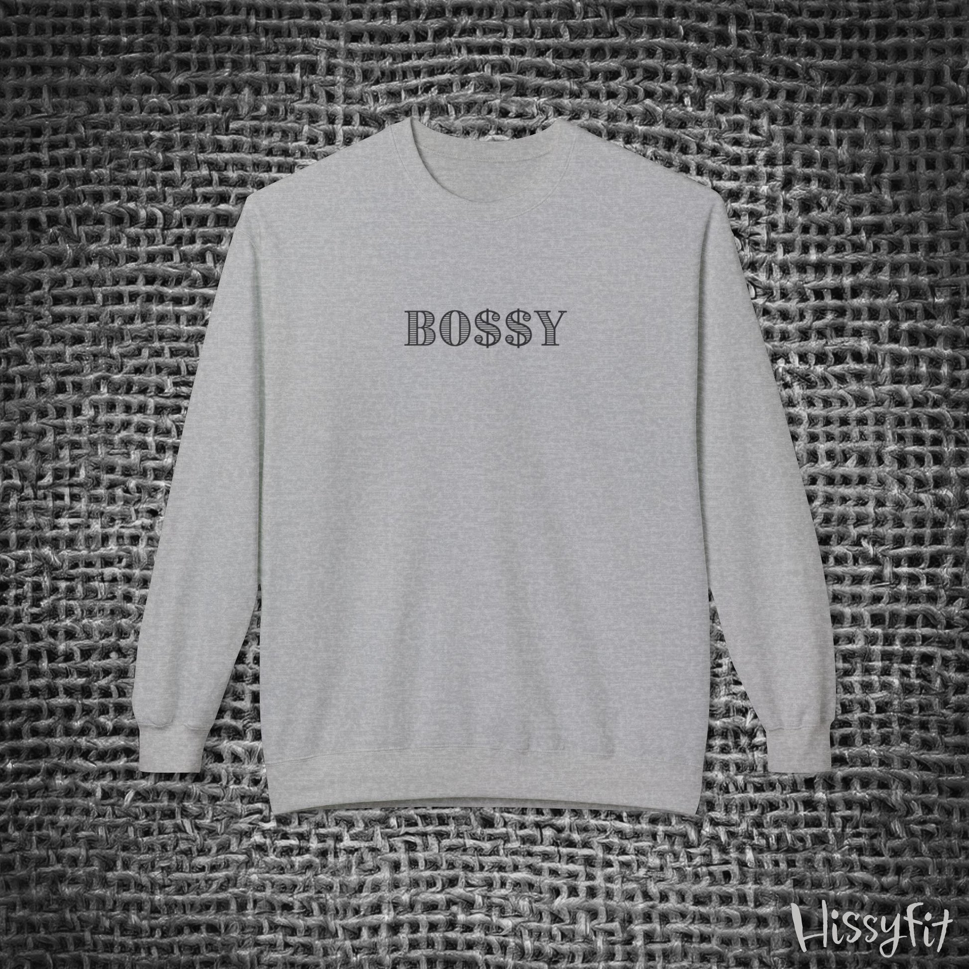 Gray sweatshirt with 'BOSSY' text on a textured black and white background