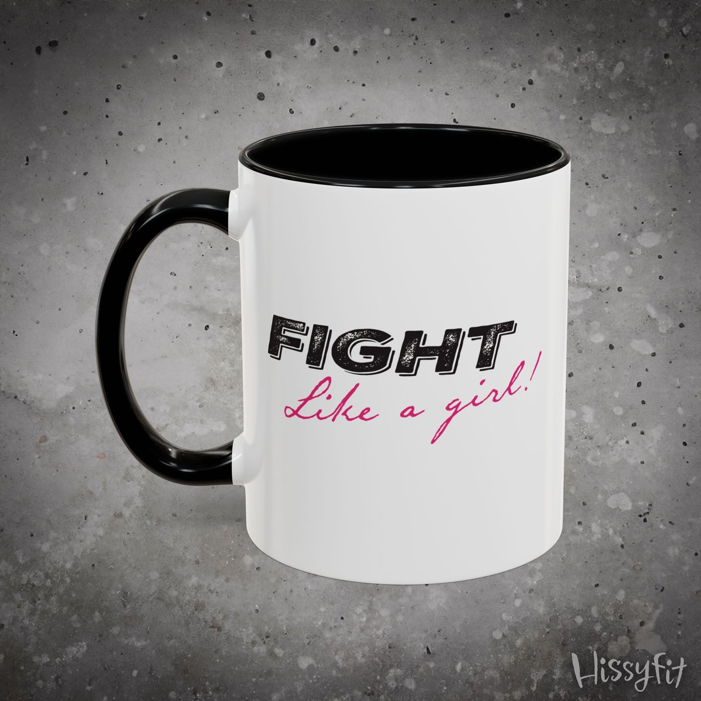 White mug with black interior and handle, featuring 'Fight Like a Girl' text on a gray background.