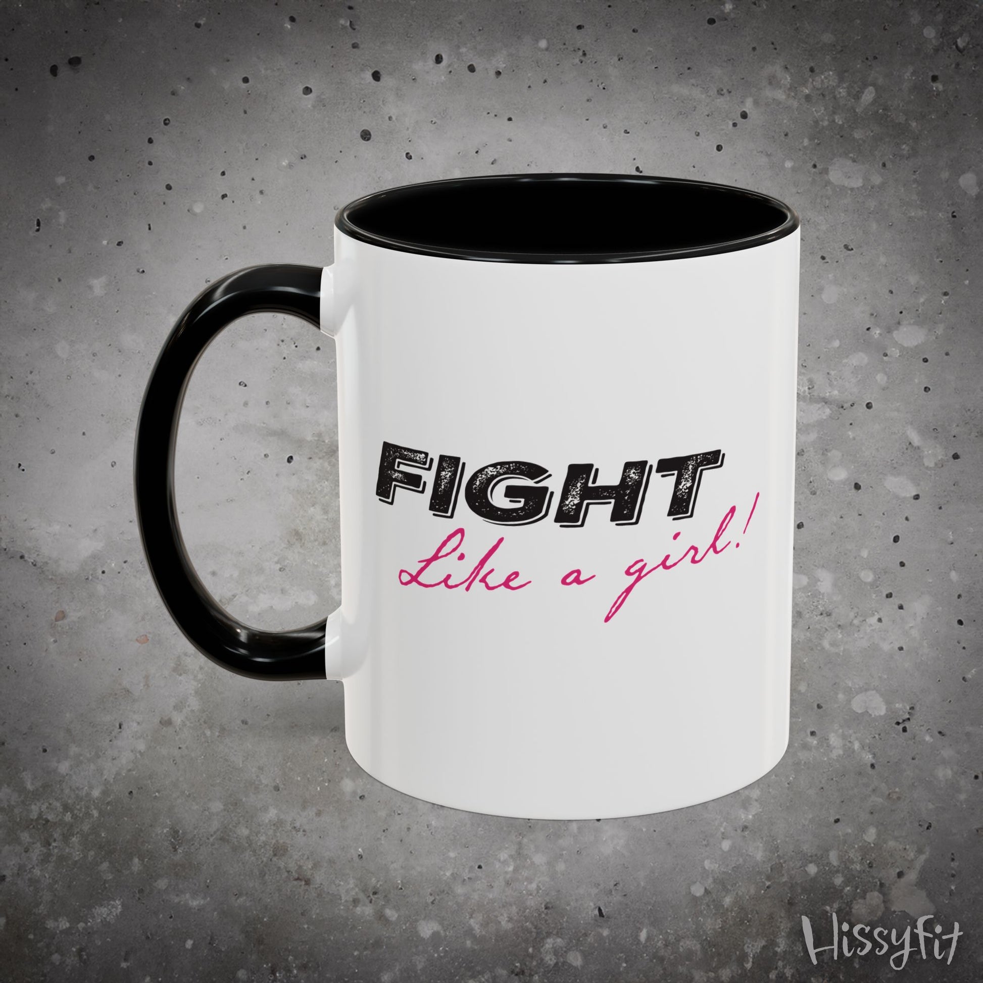White mug with black interior and handle, featuring 'Fight Like a Girl' text on a gray background.