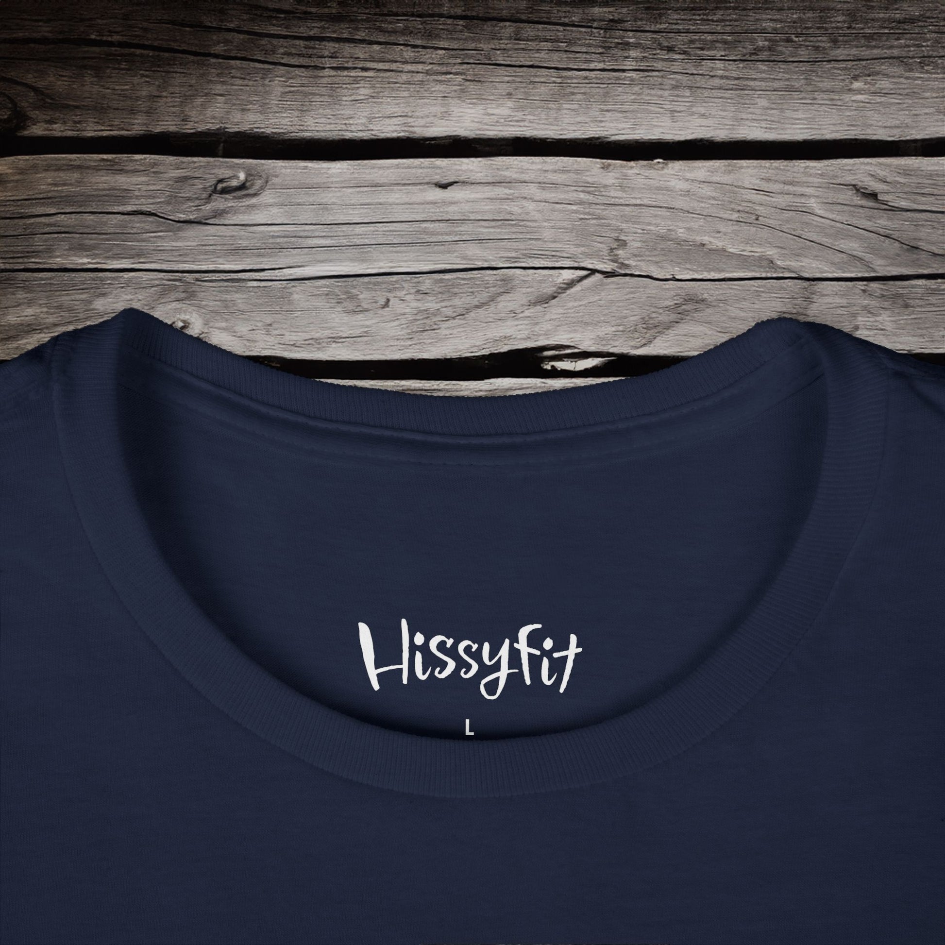 Navy blue shirt with 'Hissyfit' text on a wooden surface
