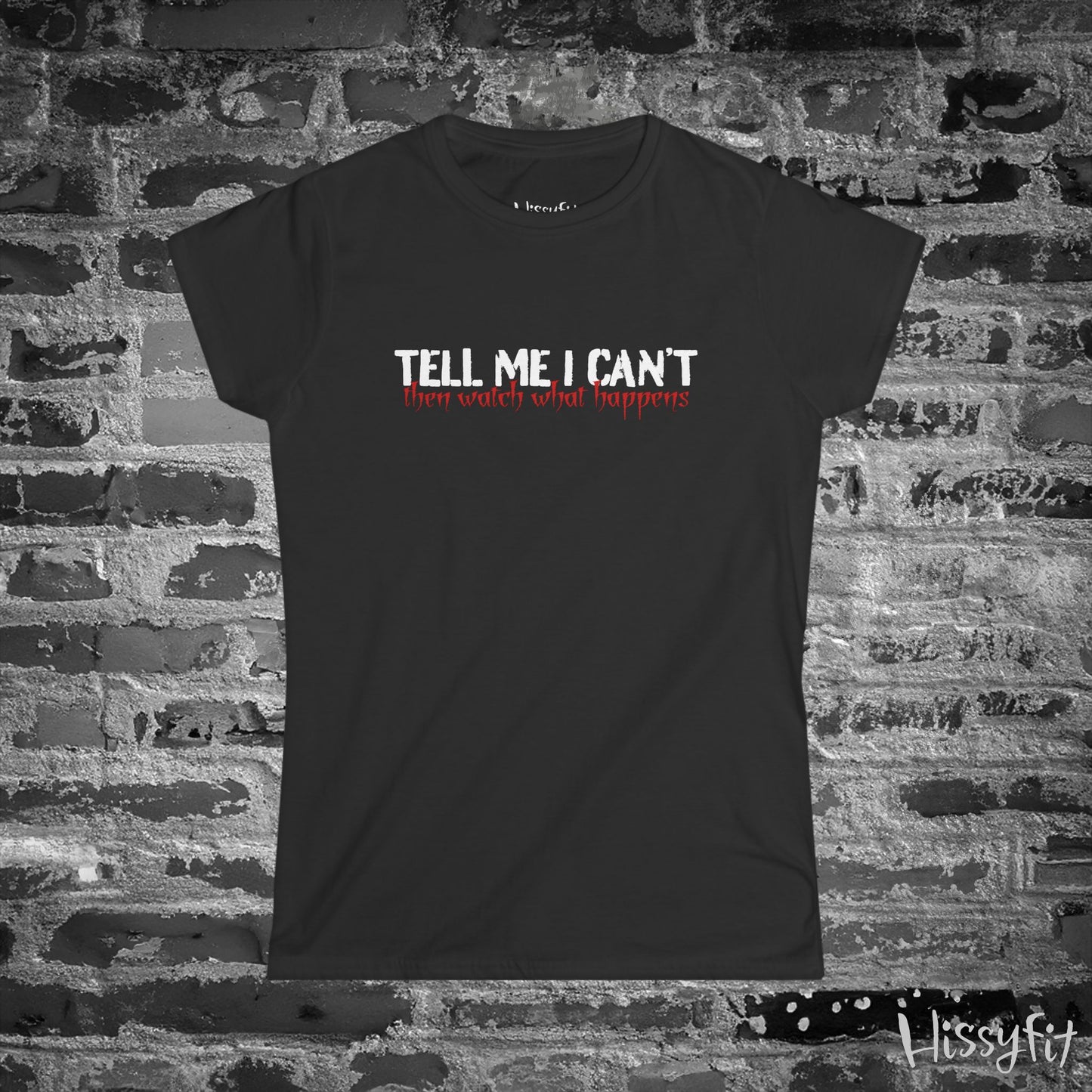 Black t-shirt with motivational quote on a brick wall background