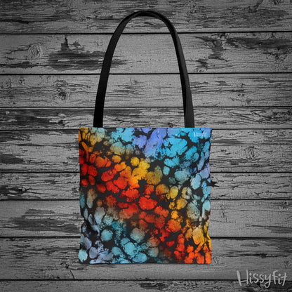 Colorful tote bag with abstract design on a wooden surface
