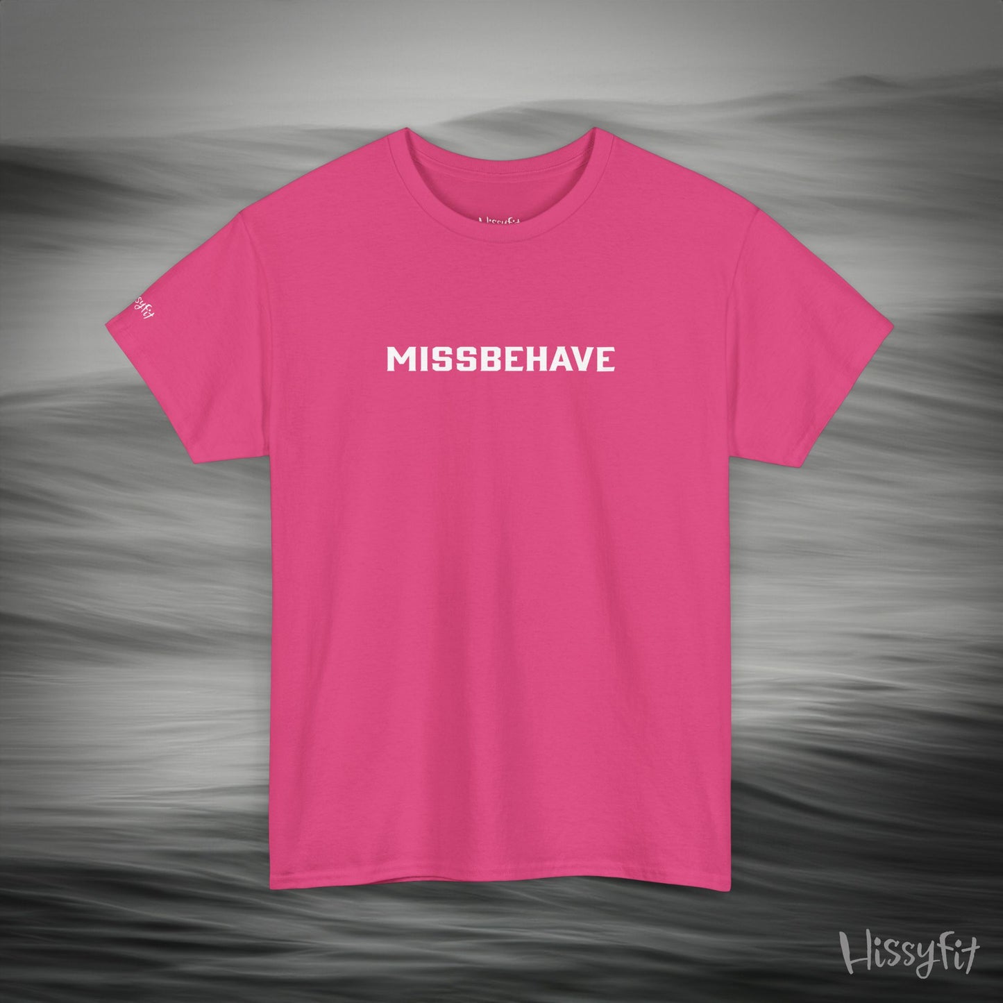 Pink t-shirt with 'MISSBEHAVE' text on a gray background