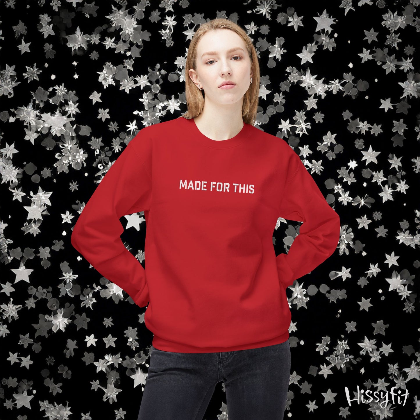 Person wearing a red sweatshirt with 'MADE FOR THIS' text against a star-patterned background