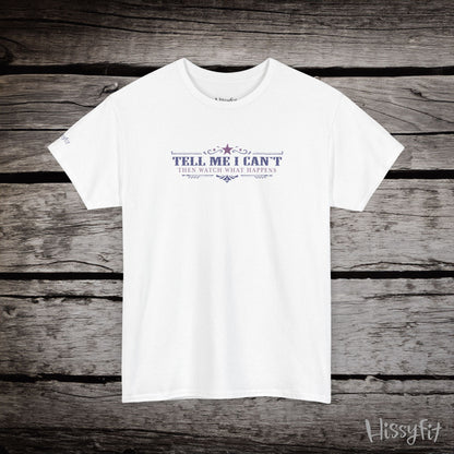 White t-shirt with text 'Tell me I can't then watch what happens' on a wooden surface, featuring the brand 'Hissyfit'.