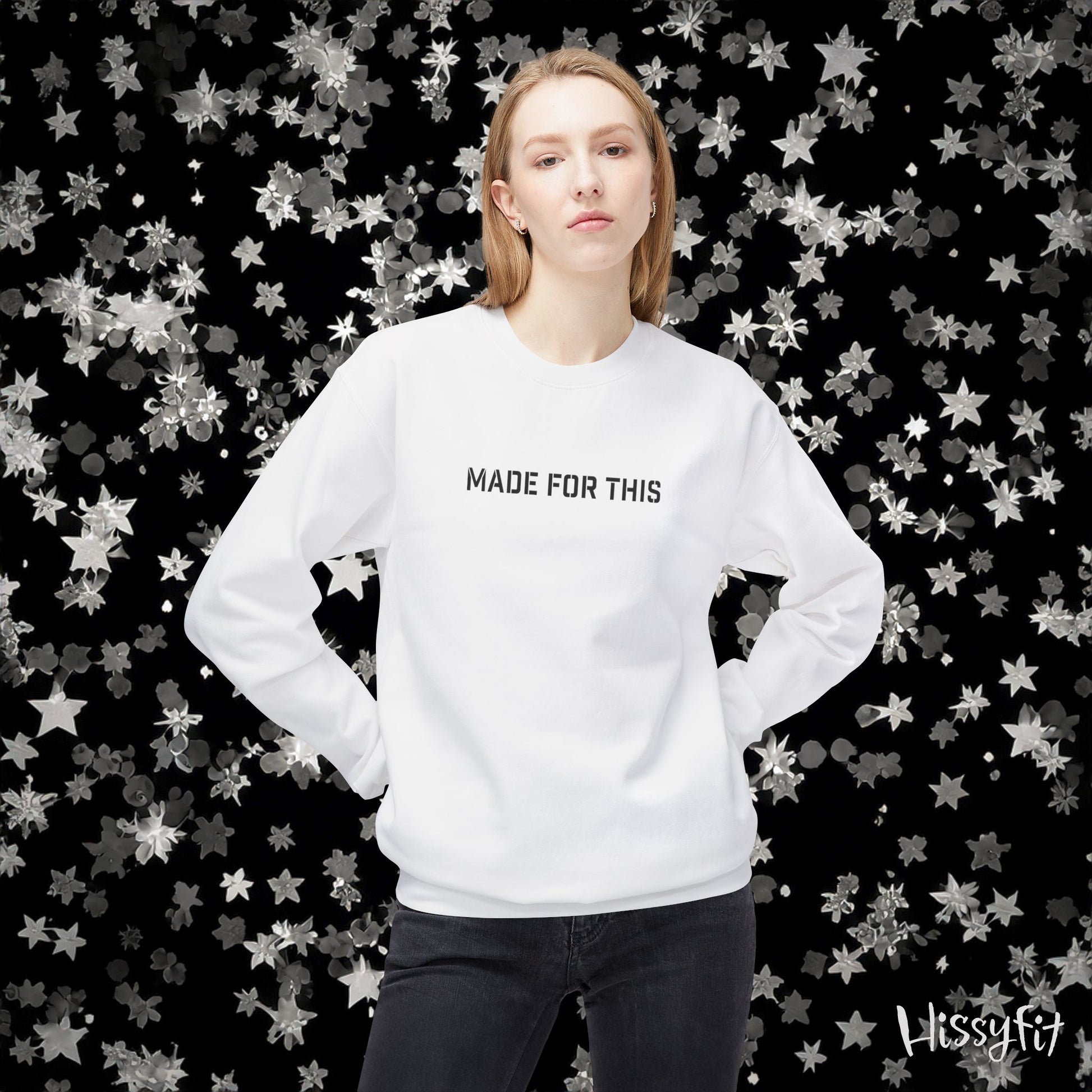 Person wearing a white sweatshirt with 'MADE FOR THIS' text against a star-patterned background