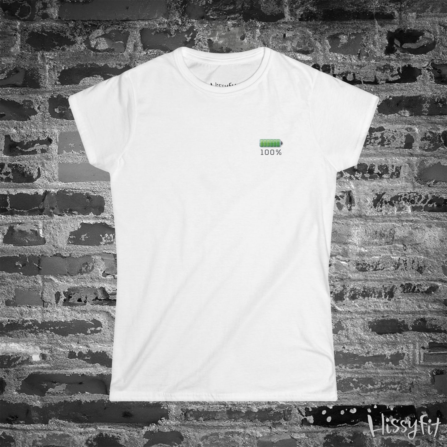 White t-shirt with a green battery symbol and '100%' charged on a brick wall background