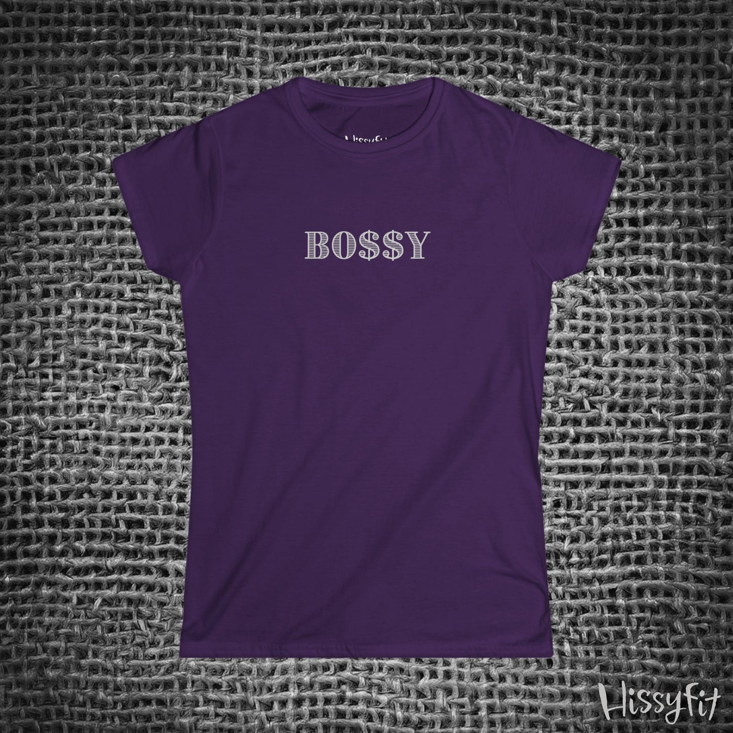 Purple t-shirt with 'BOSSY' text on a textured gray background