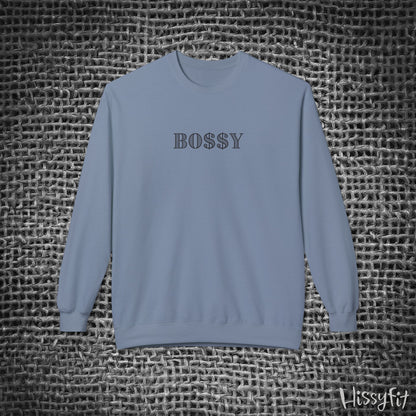 Blue sweatshirt with 'BOSSY' text on a textured gray background