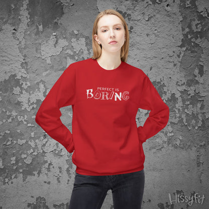 Person wearing a red sweatshirt with 'PERFECT IS BORING' text against a textured gray background