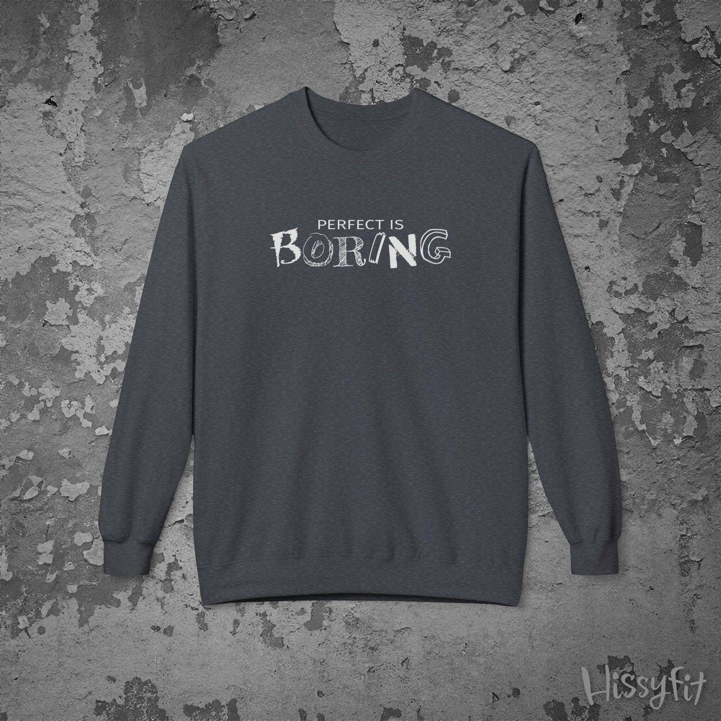 Gray sweatshirt with 'Perfect is Boring' text on a textured gray background