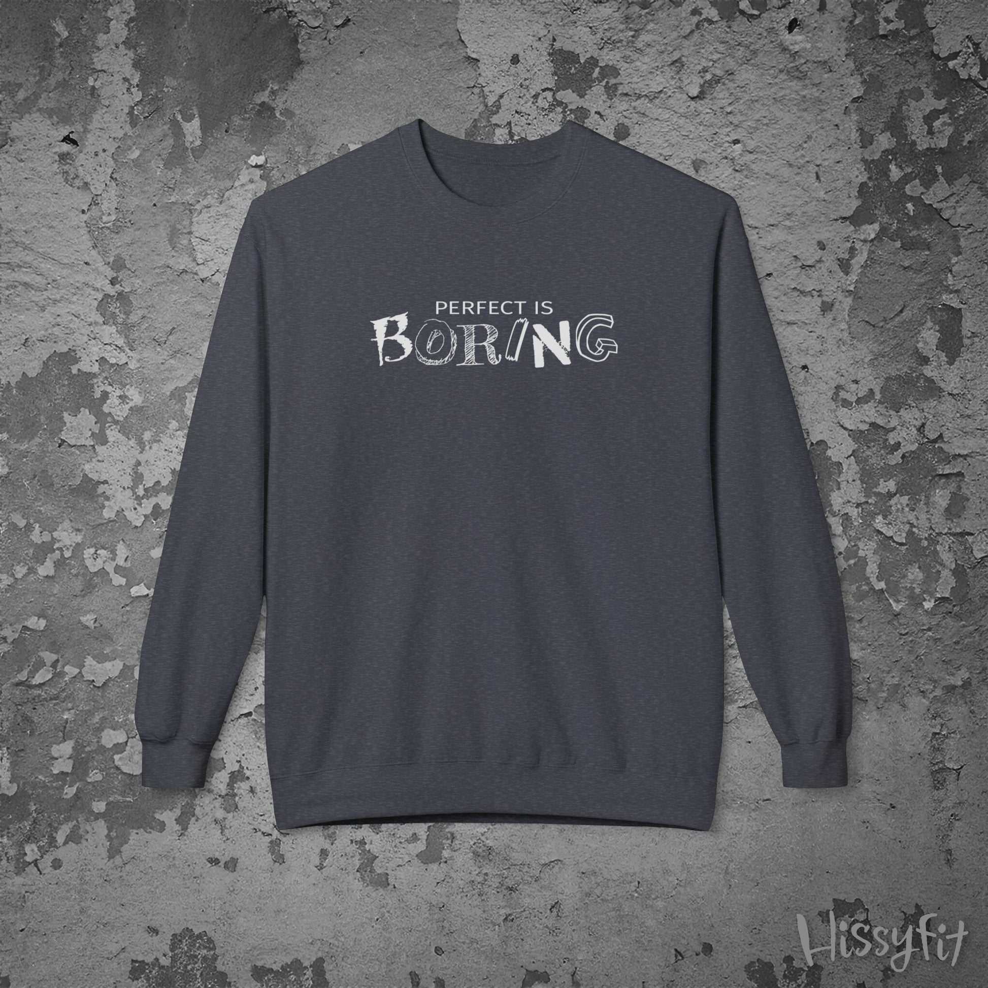 Gray sweatshirt with 'Perfect is Boring' text on a textured gray background