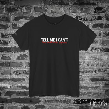 Black t-shirt with 'Tell me I can't then watch what happens' text on a brick wall background