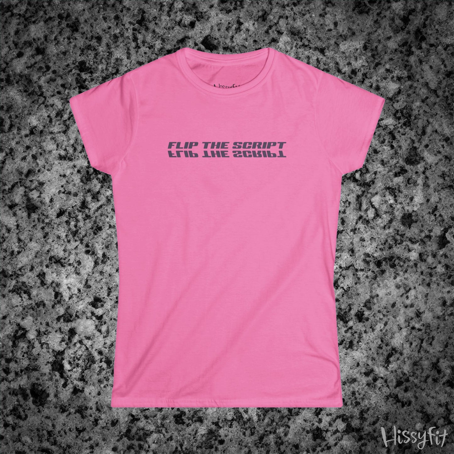 Pink t-shirt with 'FLIP THE SCRIPT' text on a gray granite surface, featuring the brand 'Hissyfit'.